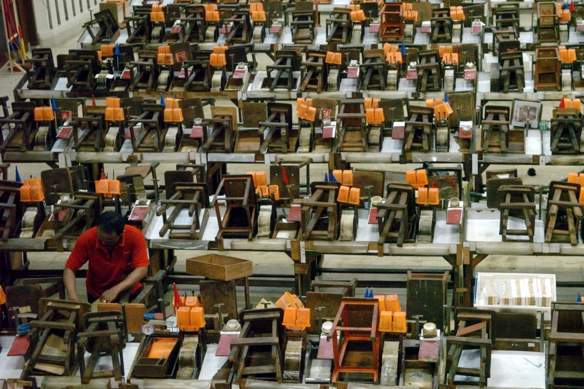 Pekerja membersihkan peralatan linting rokok setelah digunakan buruh linting di unit produksi sigaret keretek tangan di pabrik rokok di Surabaya tahun 2007.