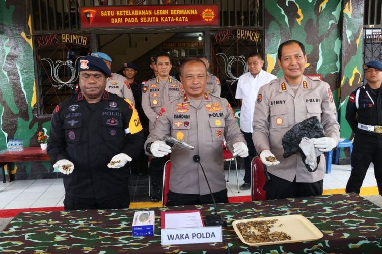 Wakapolda Papua Brigjen Ramdani Hidayat (tengah) sedang memperlihatkan satu pucuk senjata api jenis pistol semi otomatis yang ditemukan personel Brimob di wilayah hukum Jayapura, Papua, Senin (24/7/2023). 