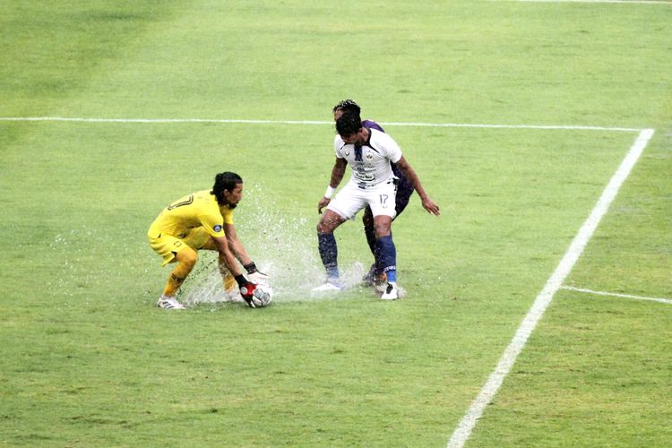 Kiper PSIS Semarang Jandia Eka Putra (kiri) coba mengamankan bola dari sergapan pemain Persik Kediri. Laga Persik Kediri vs PSIS Semarang digelar di Stadion Kapten I Wayan Dipta, Gianyar, Bali, Minggu (6/2/2022).