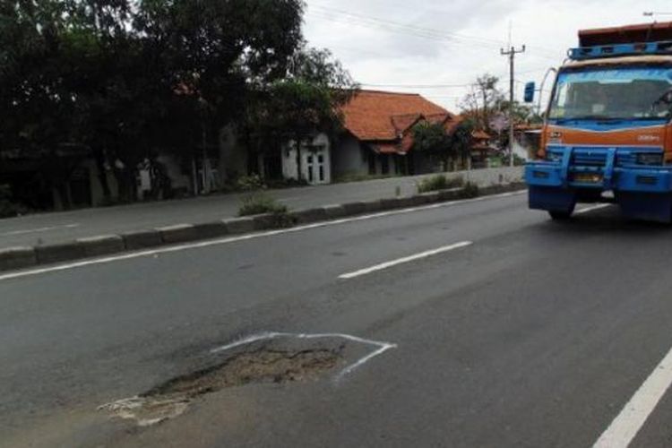 Kendaraan melintasi jalur pantai utara Jawa, tepatnya Jalan Raya Pilangsari, Kabupaten Indramayu, Jawa Barat, yang berlubang, Minggu (19/2/2017). Sejumlah jalan nasional di Cirebon dan Kabupaten Indramayu, Jawa Barat, dalam kondisi retak, bergelombang, dan berlubang. Bahkan, sejumlah ruas jalan yang telah ditambal kembali berlubang.