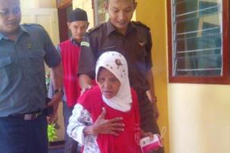 Nenek Asyani (63)harus dipapah saat menuju persidangan di PN Situbondo, Senin (9/3/2015). 