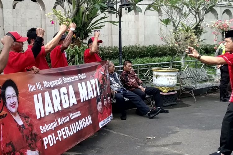 Belasan kader Partai Demokrasi Indonesia Perjuangan (PDI-P) membentangkan spanduk dukungan kepada Megawati Soekarnoputri untuk kembali menjadi Ketua Umum partai. Aksi itu dilakukan di tengah kunjungan ziarah Megawati ke Makam Bung Karno, Jumat (6/6/2025)