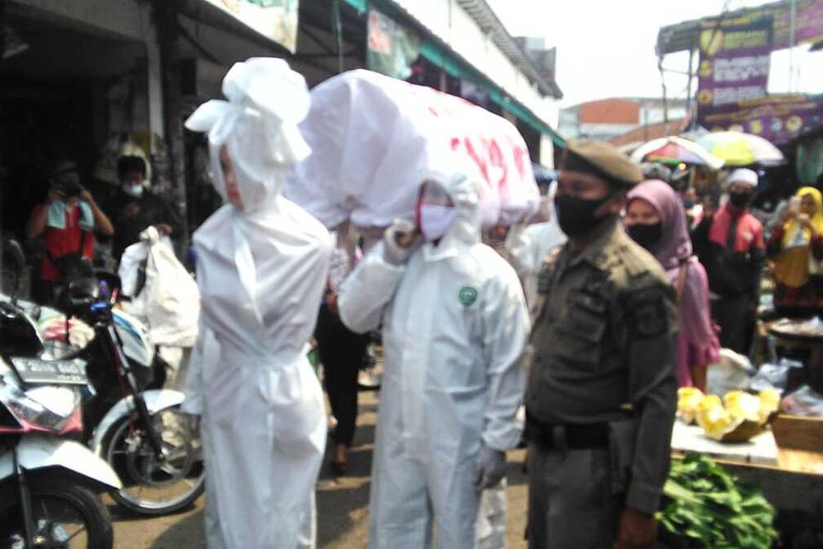 Imitative shrouded ghosts and coffin carrier are used to promote the use of masks in effort to prevent the Covid-19 spread in Cikupa sub-district in Tangerang in Banten Province, Indonesia. 