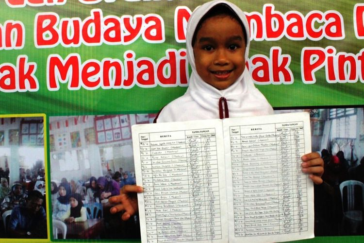 Aathifah menunjukkan buku penghubung miliknya, dia sudah membaca ratusan buku dalam satu semester pendidikannya, Jumat (28/4/2017)