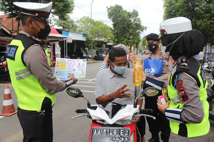 Pengendara diberi hadiah minyak goreng karena tertib berlali lintas dalam Operasi Keselamatan Lalu Lintas Candi (OKLC) di depan Mako Sat Lantas Polres Kebumen, Jawa Tengah, Senin (7/3/2022).