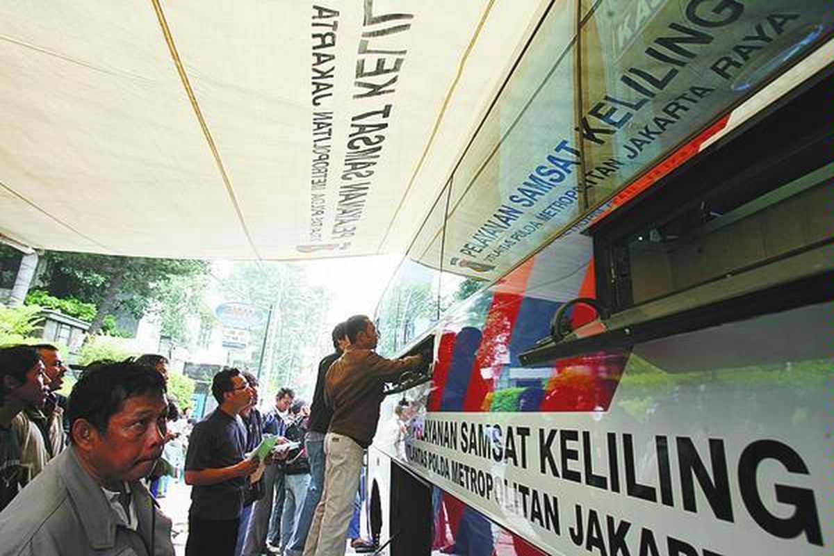 Warga membayar pajak kendaraan bermotor melalui mobil Samsat keliling di Jalan Gajah Mada, Jakarta. Pemerintah akan menaikkan tarif empat jenis pajak kendaraan bermotor 5 persen hingga 10 persen sebagai bagian dari kebijakan penurunan konsumsi bahan bakar minyak.  