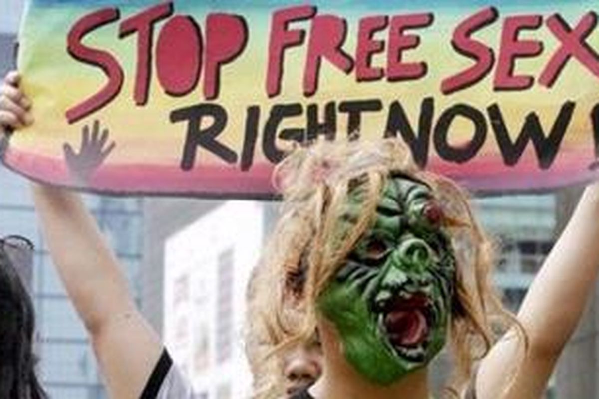 Indonesian activists hold a banner during a small rally marking the World AIDS Day in Jakarta, Indonesia, Wednesday, Dec. 1, 2010.