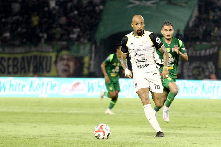 Pemain Persija Jakarta Gustavo Almeida berhasil melewati pemain Persebaya Surabaya saat laga pekan ke-9 Super League 2025-2026 yang berakhir dengan skor 1-3 yang berlangsung di Stadion Gelora Bung Tomo Surabaya, Jawa Timur, Sabtu (18/10/2025) malam.