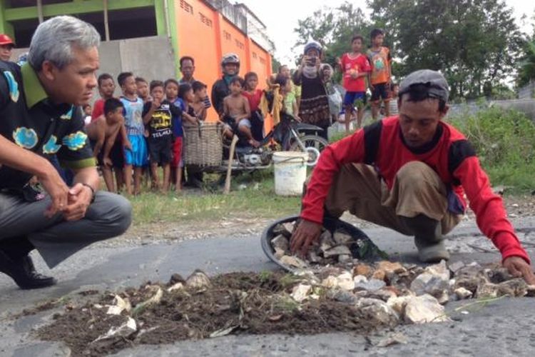 Sudarto (43) warga Grobogan, Jawa Tengah yang berprofesi tukang becak menambal jalan berlubang di wilayahnya, Rabu (8/3/2017). Sudah 19 tahun dia melakukan kegiatan itu tanpa paksaan, dan imbalan.