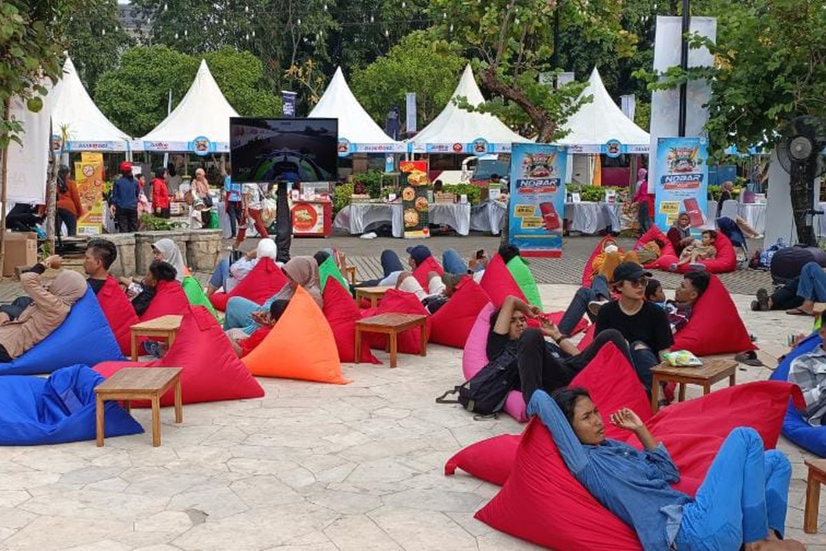 Pengunjung Pantai Ancol tampak menikmati acara nonton bareng (nobar) Formula E pada Sabtu, (3/6/2023). Mereka tampak rebahan di bean bag sambil menikmati ajang Formula E yang diputar di layar televisi berukuran 55 inci.