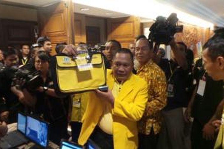 Bendahara Umum DPD Partai Golkar Provinsi Papua Achmad Goesra menyerahkan materi dan kartu peserta Musyawarah Nasional IX Partai Golkar di Hotel Westin, Nusa Dua, Bali, Selasa (2/12/2014).
