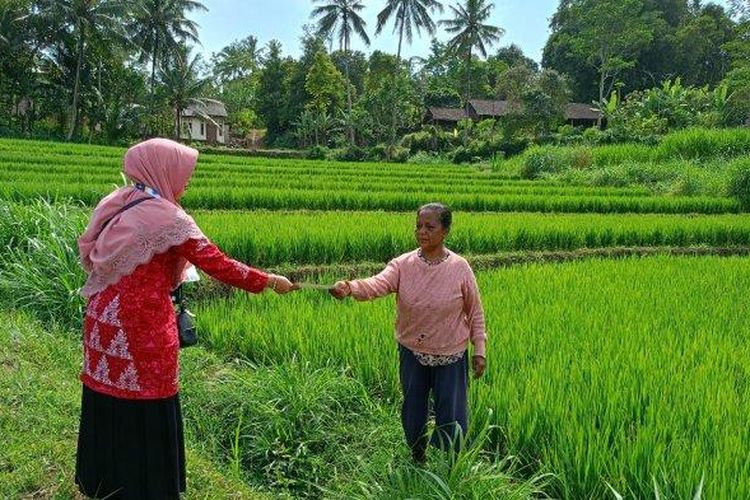 Kepala Sekolah SD Negeri Sugihan 03, Septiana Ika Kadarsih bersama guru membagikan brosur ke lokasi-lokasi warga sekitar sekolahan untuk menarik anak-anaknya mendaftar, Rabu (7/6/2023). 
