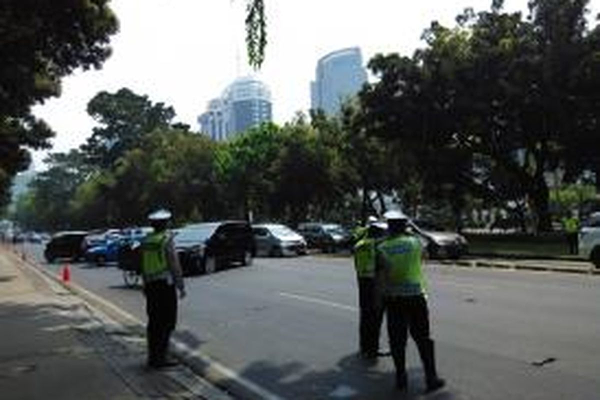 Kendaraan berputar arah di jalan Medan Merdeka Barat saat demo buruh, Jumat (30/10) siang