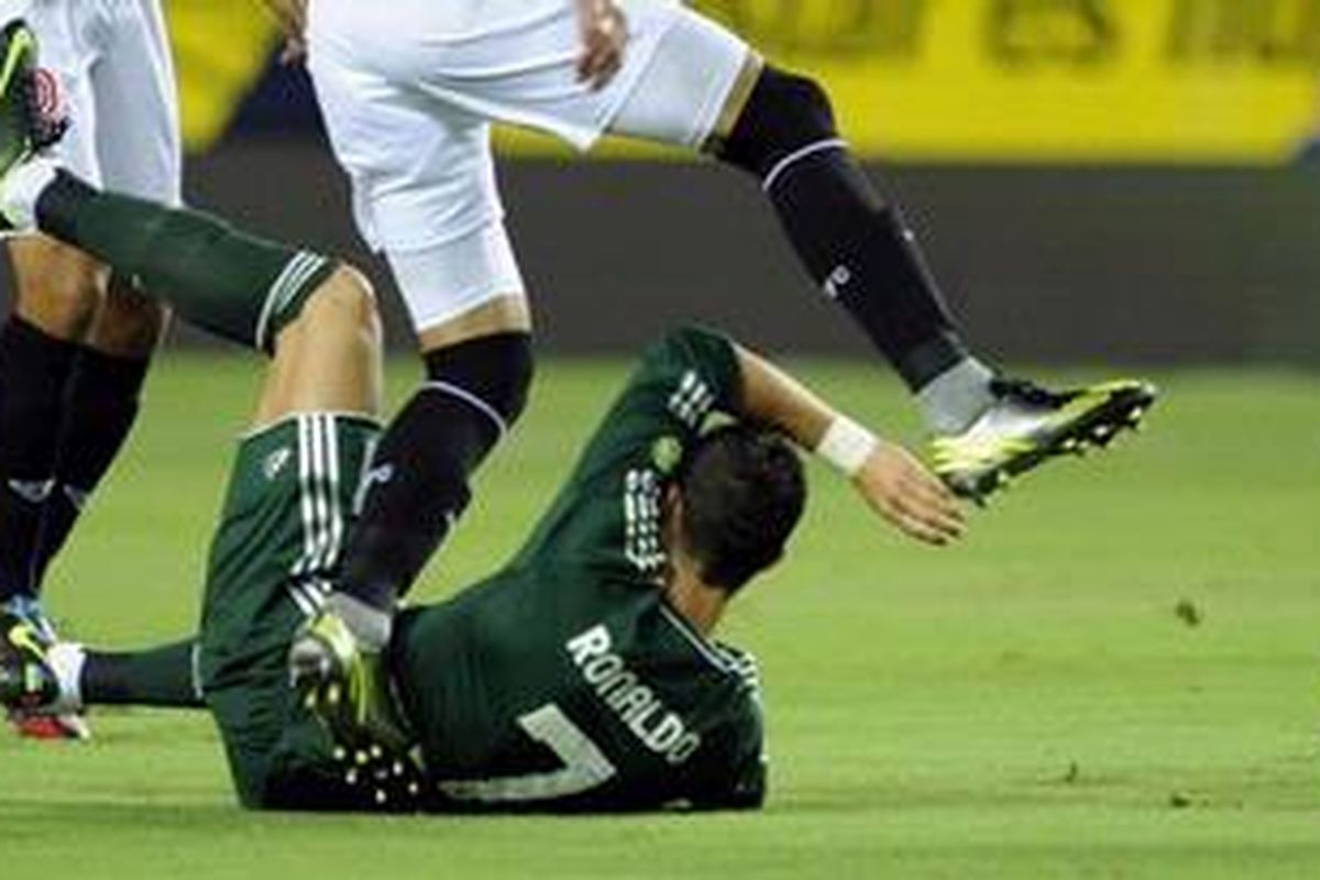 Seorang pemain Sevilla melompati bomber Real Madrid, Cristiano Ronaldo, dalam lanjutan Liga BBVA di Stadion Ramon Sanchez Pizjuan, Sabtu (15/9/2012). Madrid sementara tertinggal dari Sevilla 0-1 di paruh pertama. 