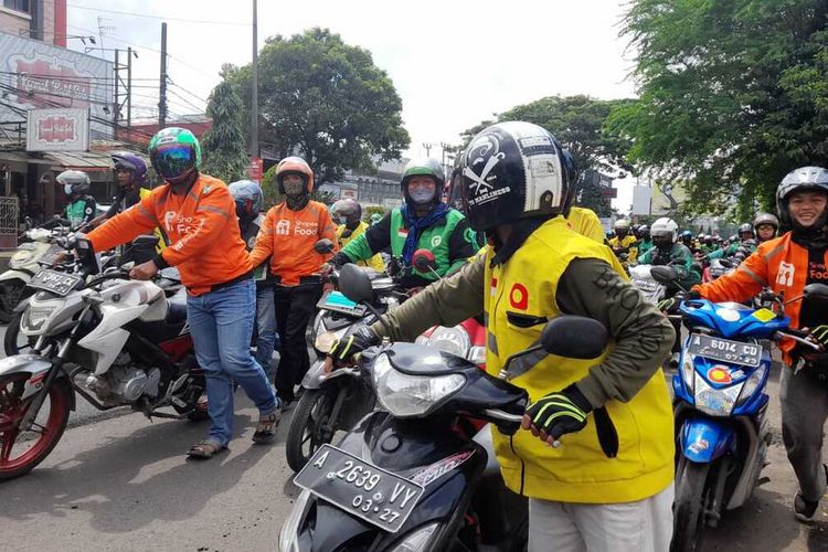 Aksi menuntun motor para pengemudi ojek online di Kota Serang, Banten. Mereka menyampaikan aspirasi di depan Kantor Gubernur Banten