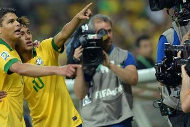 Striker Brasil, Neymar (kanan) dan bek Thiago Silva, menunjuk ke arah suporter ketika Brasil menang 2-1 atas Uruguay di semifinal Piala Konfederasi. Brasil akan hadapi Spanyol di final, Minggu (30/6/2013).