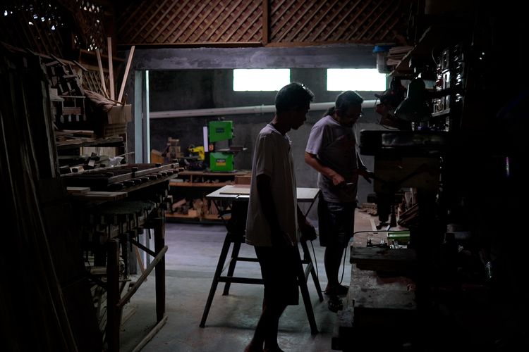 Dua pekerja menyelesaikan pembuatan gitar akustik berbahan bambu di rumah produksi Lembaga Pendidikan Seni Nusantara (LPSN) di kawasan Bogor Barat, Bogor, Jawa Barat.