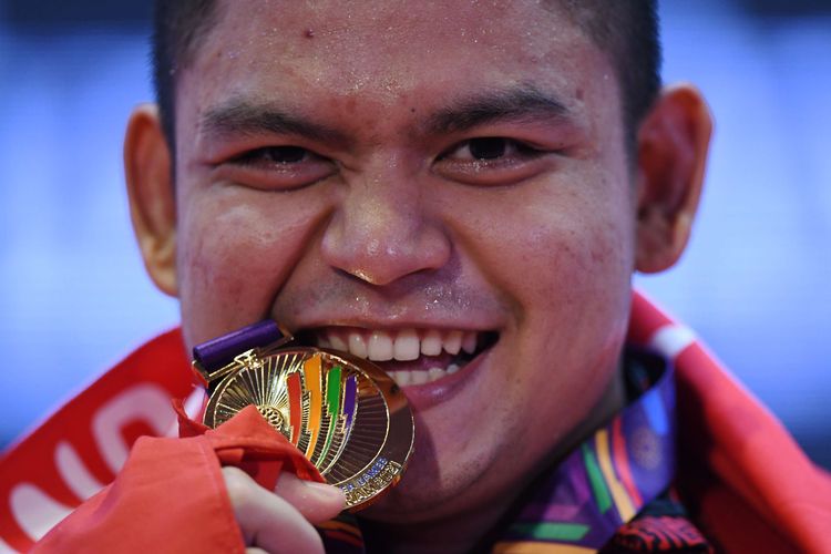 Lifter Indonesia Muhammad Zul Ilmi berpose dengan medalinya usai pengalungan medali nomor 89 kilogram angkat berat SEA Games 2021 Vietnam di Hanoi Sports Training Centre, Hanoi, Vietnam, Minggu (22/5/2022). Zul Ilmi meraih medali emas setelah terbaik dalam total angkatan 337 kilogram.