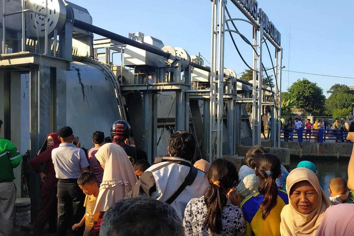 Warga berkerumun di sekitar ATR (auto trash rake -- mesin automatis pengangkut sampah) Kalimalang dekat persimpangan Poncol, Bekasi Timur, lokasi ditemukannya mayat pria tanpa identitas, Selasa (10/9/2019).