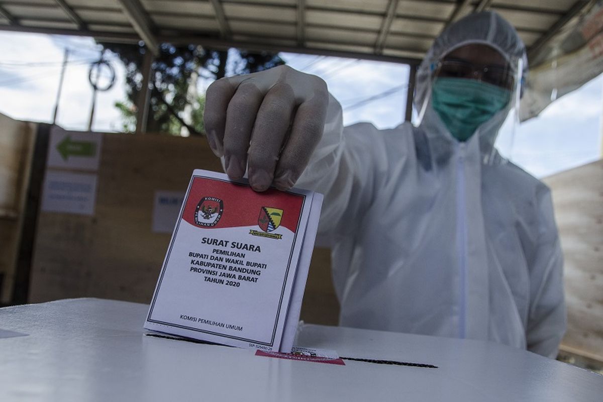 A voter in full PPE [Protective Personal Equipment] casts his ballot in Bandung, West Java, Wednesday (9/12/2020). ANTARA FOTO/Novrian Arbi/wsj.