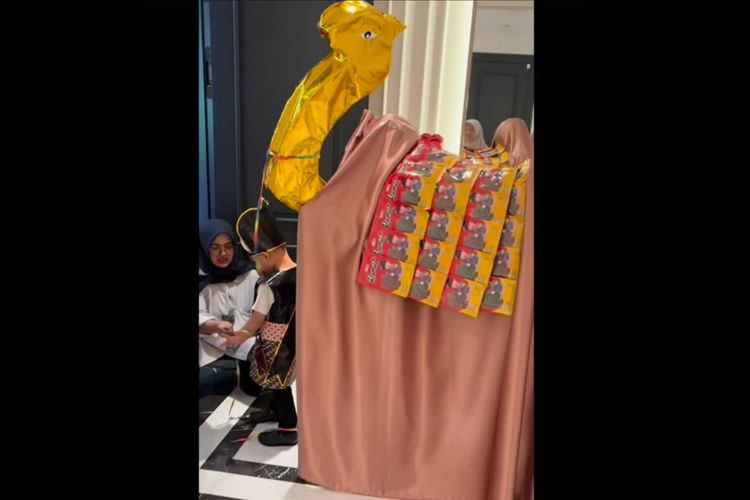 Rayyanza membawa pedang dan menggandeng seekor unta emas yang bukan hewan sungguhan.