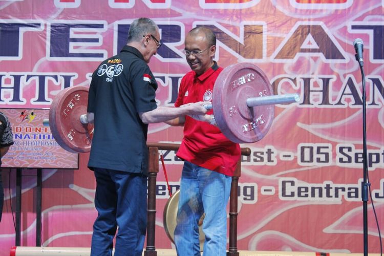 Sesmenpora Gatot S Dewa Brata menerima barbel dari Wakil Ketua PB PABBSI Joko Pramono dalam acara pembukaan The 2nd Junior Indonesia Weightlifting Championships di GOR Tri Lomba Juang, Semarang, Sabtu (31/8/2019).