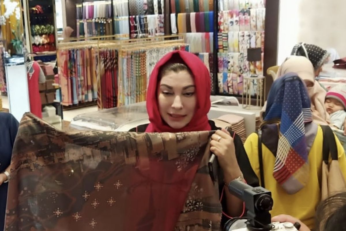 Pemilik brand hijab Alisha, Zareena Servia, tengah mempelihatkan pasmina di tokonya.