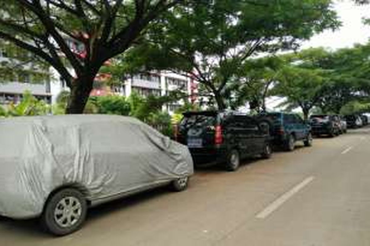 Mobil-mobil yang dibawa warga penghuni Rusun Marunda, Cilincing, Jakarta Utara, diparkir di pinggir jalan, Jumat (29/4/2016).