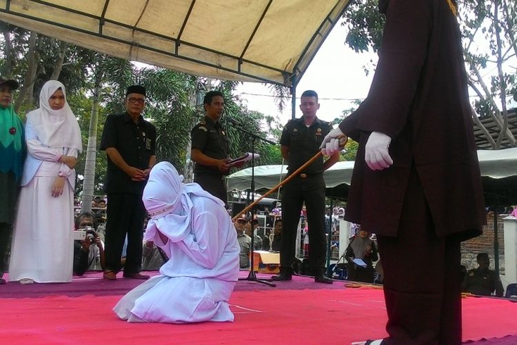 Terbukti bermesraan dengan bukan pasangan sah, perempuan ini menjalani hukuman cambuk sebanyak 23 kali, yang dilaksanakan di halaman Mesjid Lamteh, Banda Aceh, Senin (20/03/2017). Sebanyak 12 pelanggar syariat islam dihukum cambuk pada kesempatan yang sama karena terbukti melanggar hukum syariat silam.