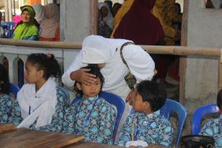 Salah seorang warga tampak haru mencium kepala anak yatim di Desa Plosogede, Kecamatan Ngluwar, Kabupaten Magelang, Senin (3/11/2014).