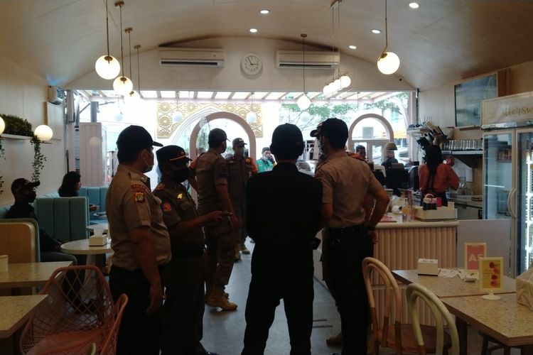 Satpol PP Kota Depok mendatangi salah satu restoran di Jalan Margonda Raya, Pondok Cina, Beji, Depok, karena kedapatan antrean yang mengular hingga ke jalanan, pada Senin (11/4/2022).