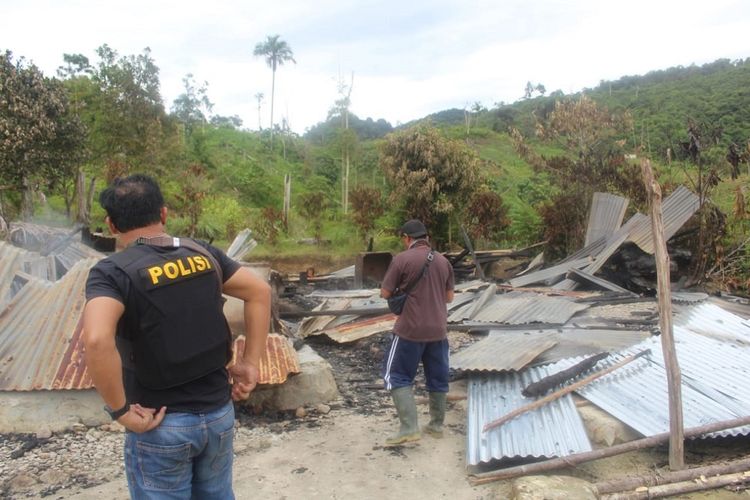 Polisi memeriksa bangunan yang dibakar dalam serangan yang diduga dilakukan oleh kelompok teroris Mujahidin Indonesia Timur (MIT) pimpinan Ali Kalora di Dusun Lewonu, Desa Lemban Tongoa, Kecamatan Palolo, Kabupaten Sigi, Sulawesi Tengah, Sabtu (28/11/2020). Serangan yang diduga dilakukan kelompok teroris MIT pimpinan Ali Kalora yang terjadi pada Jumat (27/11/2020) tersebut menewaskan empat orang warga, beberapa rumah warga dibakar dan mengakibatkan warga mengungsi ke tempat yang aman. Hingga kini aparat TNI dan Polri yang tergabung dalam Satgas Tinombala bersama Kepolisian setempat masih berupaya mengejar para pelaku. ANTARA FOTO/Humas Polres Sigi/Handout/wsj.