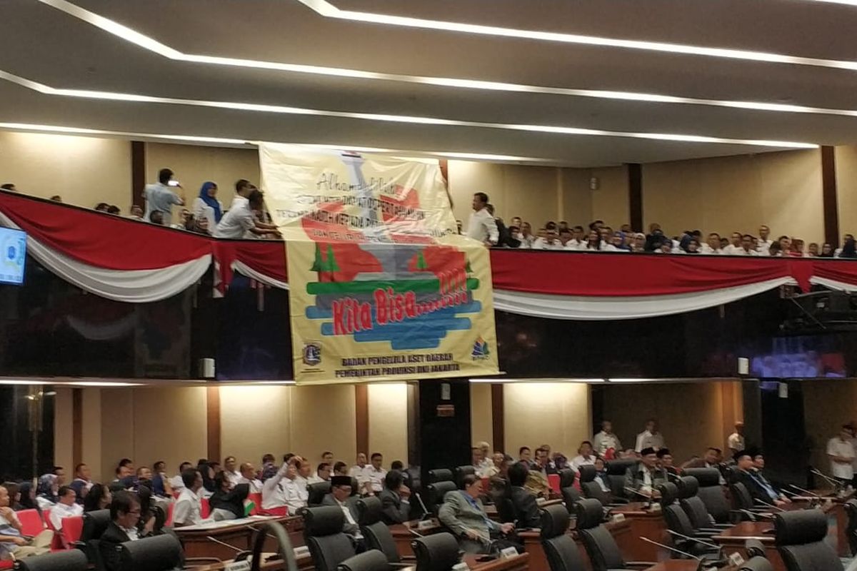 PNS Pemprov DKI membentangkan spanduk atas peraihan opini wajar tanpa pengecualian (WTP) laporan keuangan Pemprov DKI tahun 2018, di ruang rapat paripurna, Rabu (15/5/2019).