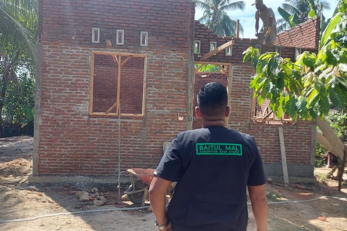 Masyarakat melihat proses pembangunan rumah di Desa Panigah, Kecamatan Muara Batu, Kabupaten Aceh Utara, Jumat (14/8/2020)