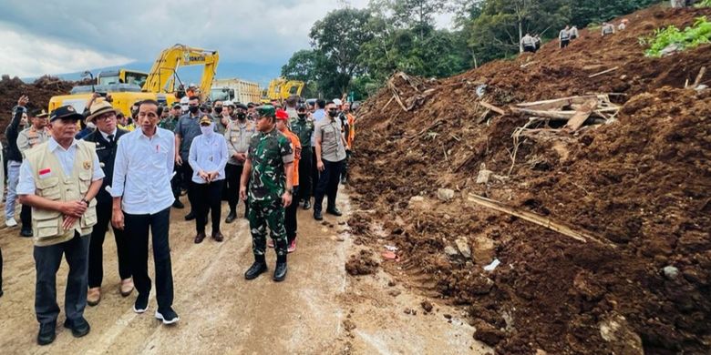 Indonesia's President Joko Widodo (right, front), who is accompanied by local authorities visit the affected areas in Cugenang sub-district in Cianjur regency on Tuesday, November 22, 2022, a day after the 5.6-magnitude quake struck Indonesia's West Java. 