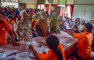 Sejumlah petugas Kantor Pos melayani ratusan warga penerima bantuan sosial atau Bansos di kantor Negeri Waai, Kabupaten Maluku Tengah, Provinsi Maluku, Kamis (14/4/2022). Pemerintah melalui Kementerian Sosial pada April 2022 mulai menyalurkan Bansos Kartu Sembako atau Bantuan Pangan Non Tunai (BPNT) kepada setiap keluarga penerima manfaat sebesar Rp200.000, dan juga Bantuan Langsung Tunai Subsidi minyak goreng Rp300.000 untuk tiga bulan periode April-Juni 2022.