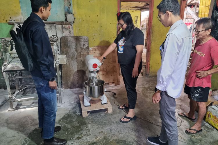 Pemilik Istana Roti Bakery, Diana Wati mencoba alat pengaduk adonan kue bantuan dari PT Bukit Asam Tbk