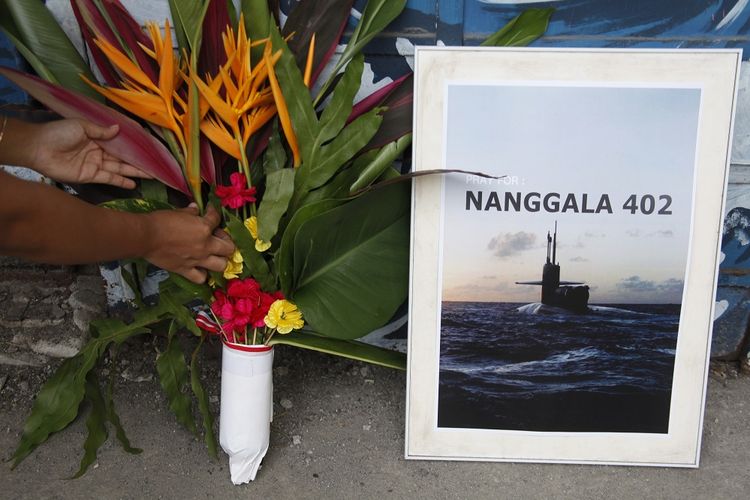 Peoples carry flowers and pray for the entire crew of the KRI Nanggala-402 submarine who went missing in the waters north of Bali Island during a sympathetic action in Solo, Central Java, Sunday, April 25.