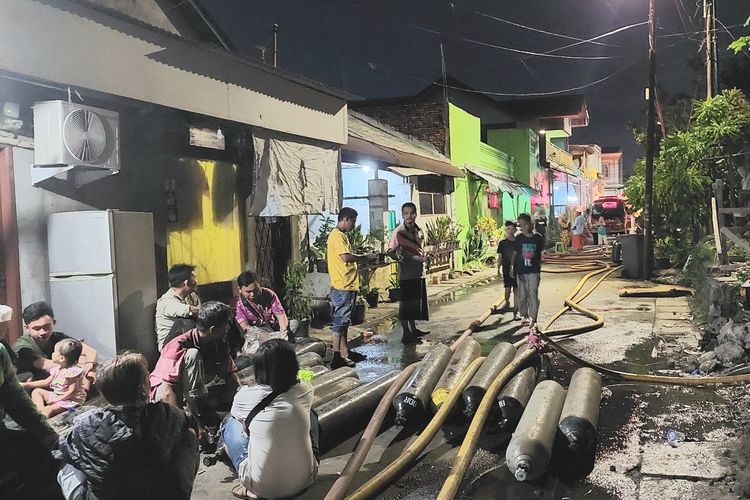Belasan pria hanya bisa terduduk di jalan dengan mata yang tentu arah usai kebakaran melanda permukiman rumah semi permanen  dan lapak rongsok di Kedoya Selatan, Kebon Jeruk, Jakarta Barat, pada Selasa (13/12/2022) malam. 