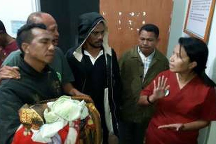 Salah seorang keluarga sedang menggendong jenasah bayi Debriana Nubatonis dan ditahan oleh perawat di Rumah Sakit Umum Daerah  (RSUD) Soe, Kabupaten Timor Tengah Utara (TTU), Nusa Tenggara Timur,Rabu (14/12/2016) 