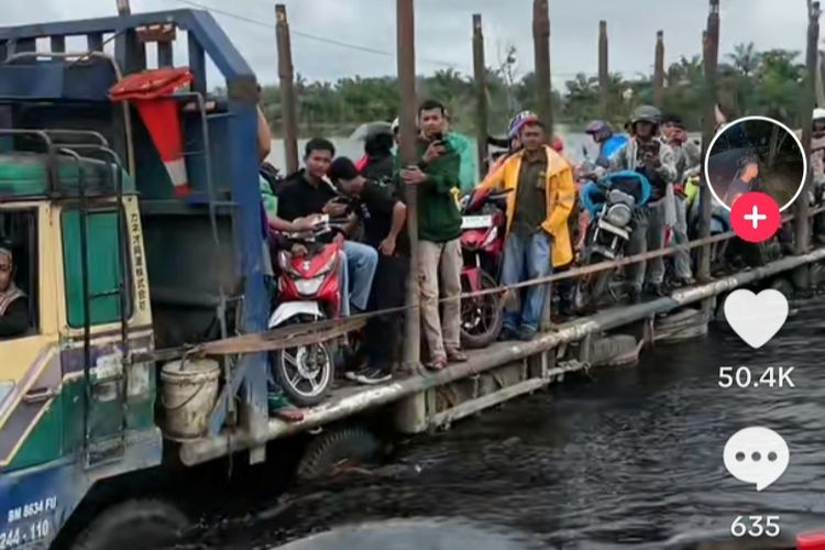 Tangkapan video viral warga membawa sepeda motor dengan truk melewati jalan lintas timur sumatera yang terendam banjir di Desa Kemang, Kecamatan Pangkalan Kuras, Kabupaten Pelalawan, Riau, Sabtu (13/1/2024).