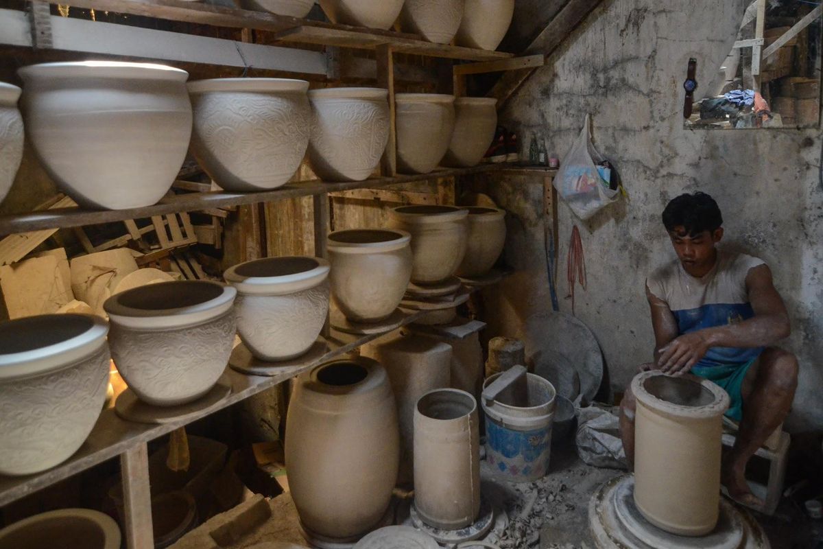 Salah satu pengrajin keramik Indonesia terlihat sedang membuat melakukan aktivitasnya yakni membuat keramik.