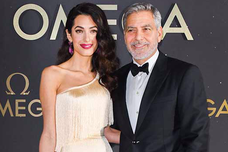 Amal Clooney saat mendampingi suaminya, George Clooney.