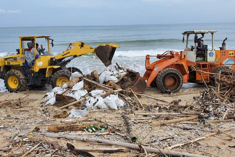 Petugas DLHK Badung membersihkan sampah kayu di pantai Kuta, Selasa (10/3/2020). 