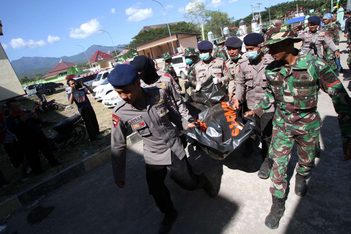 Petugas membawa kantung mayat di RSUD Lombok Utara, Tanjung, Lombok Utara, NTB, Selasa (7/8/2018). Berdasarkan data BNPB mencatat sedikitnya 105 korban meninggal dunia dan 236 korban mengalami luka luka akibat bencana gempa bumi yang terjadi Minggu (5/8/2018) dan kemungkinan masih akan bertambah.