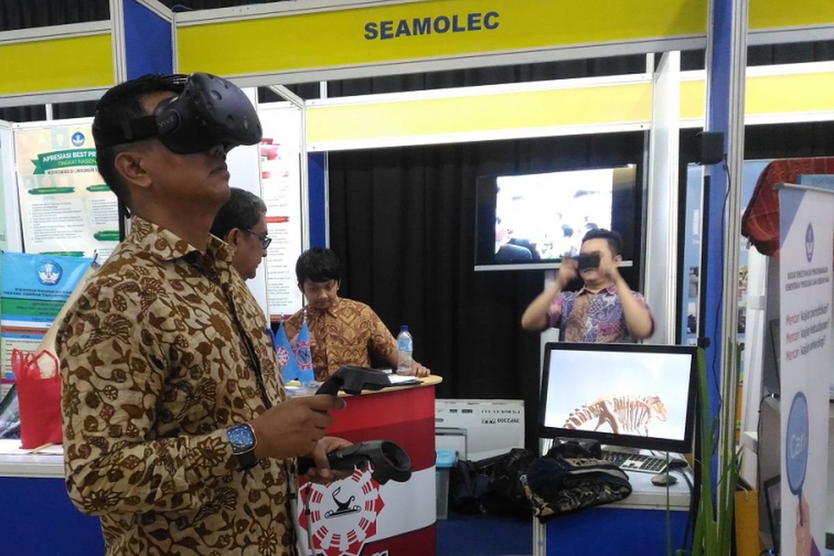 Seorang guru mencoba teknologi visual reality yang memaparkan materi pembelajaran pada pameran Hari Guru Nasional 2017 di kantor Kemdikbud. Penggunaan teknologi dalam dunia pendidikan mesti terus ditingkatkan untuk mewujudkan generasi emas pada 2045. 