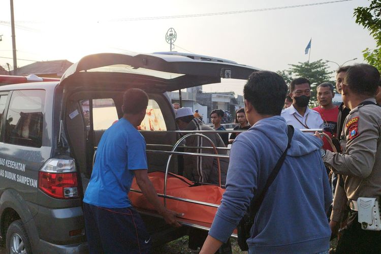 Jasad korban dimasukkan ke dalam mobil ambulans usai tertabrak kereta api di perlintasan depan Gapura Desa Pandanan, yang berada di Kecamatan Duduksampeyan, Gresik, Jawa Timur, Senin (8//2023)