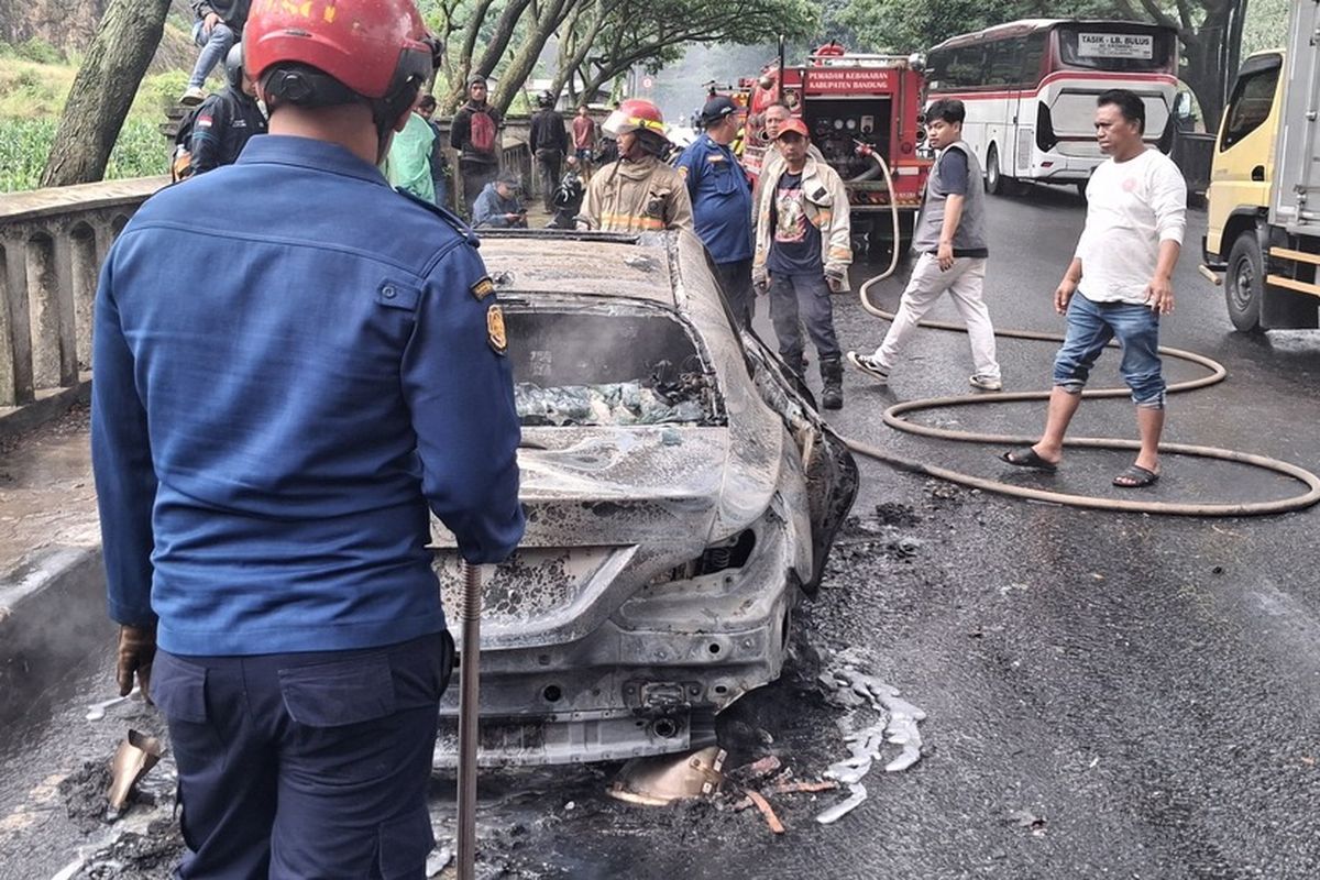 Sebuah mobil sedan mewah terbakar hebat di ruas Jalan Raya Lingkar Nagreg, Desa Ciherang, Kecamatan Nagreg, Kabupaten Bandung, Jumat (6/2/2026) siang.