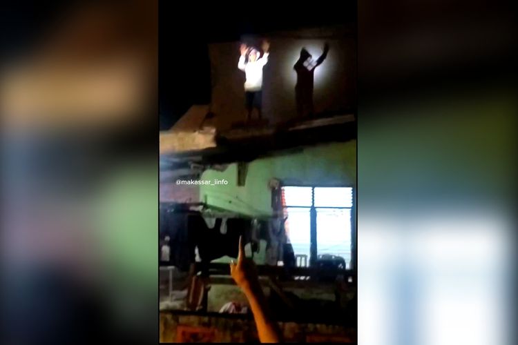 ANGKAT TANGAN: Potongan video pria yang diduga hendak melakukan aksi pencurian kepergok warga dan mengangkat kedua tangannya di atas atap rumah, di Jalan Pa'bentengan, Kecamatan Tamalate, Kota Makassar, Sulsel, Senin (11/3/2024) malam.