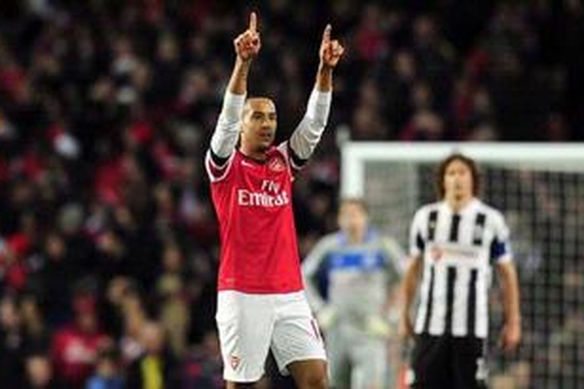 Pemain sayap Arsenal, Theo Walcott (kiri), merayakan golnya ke gawang Newcastle United, pada pertandingan Premier League, di Emirates, Sabtu (29/12/2012). 